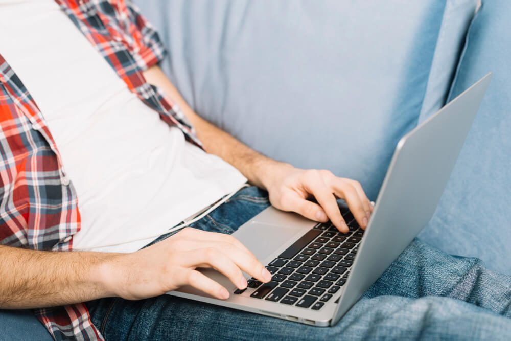 Man wear check shirt using laptop | TechReviewGarden