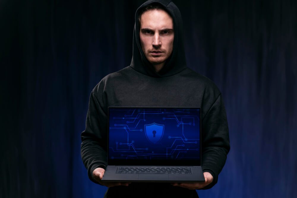 Cyber Security Expert Man standing with laptop, lock image on laptop screen | TechReviewGarden