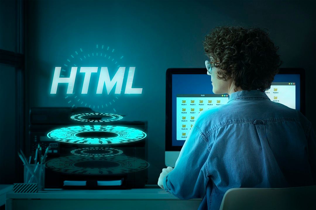 Man in Front of Desktop Computer With HTML Nion Text
